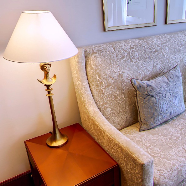 Figural brass lamp beside the sofa