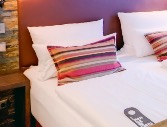 Striped accent cushion on the bed