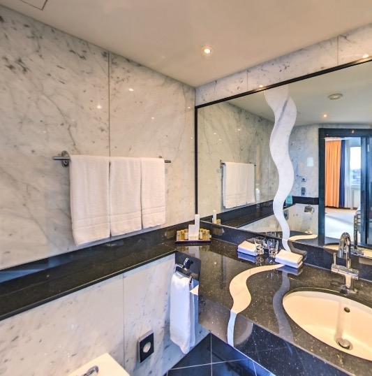 Marble-clad bathroom with towels
