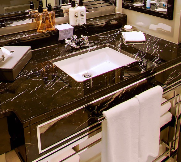 Black marble vanity with toiletries